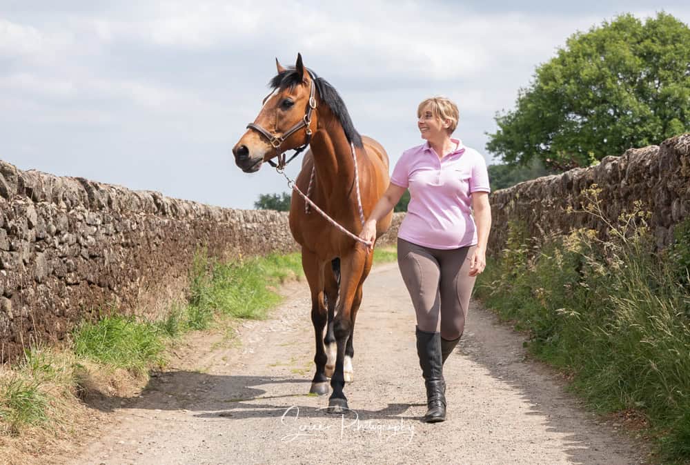 Equine portrait photography nottingham lady female horse owner walking her horse down the lane